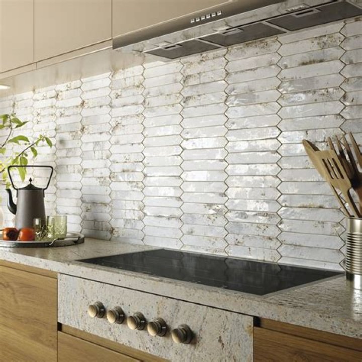 How do you prepare a wall for a glass tile backsplash?
